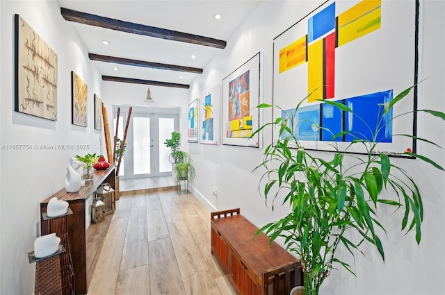 corridor featuring baseboards, beamed ceiling, recessed lighting, french doors, and light wood-style floors