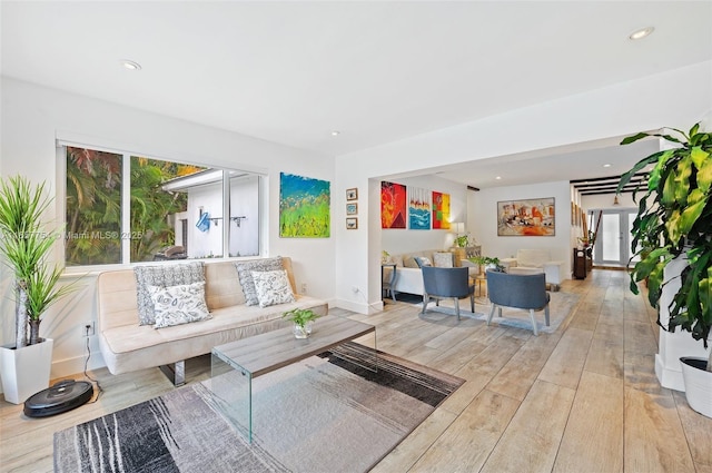 living area with recessed lighting, wood finished floors, and a wealth of natural light