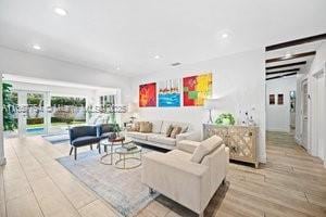 living room featuring recessed lighting, wood finished floors, and french doors