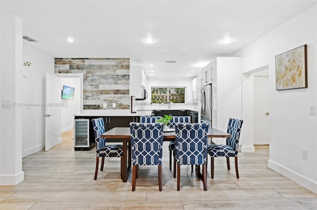 dining space with visible vents, baseboards, beverage cooler, recessed lighting, and light wood-style floors