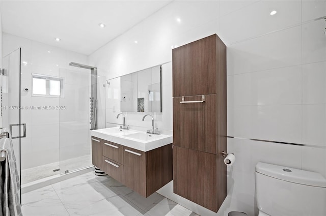 full bathroom featuring a shower stall, toilet, marble finish floor, and a sink