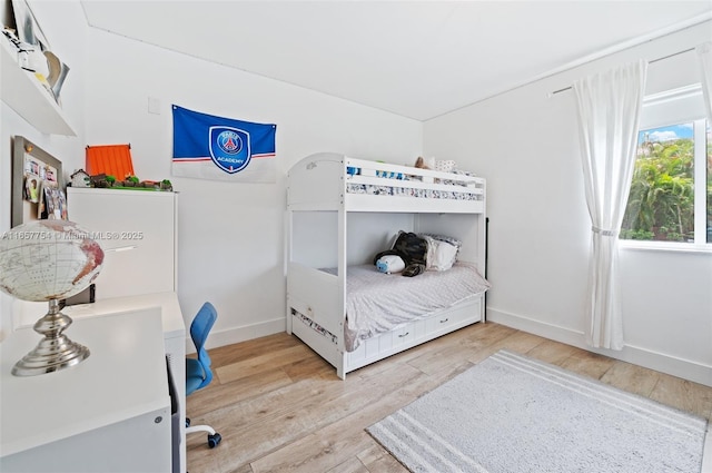 bedroom featuring baseboards and wood finished floors