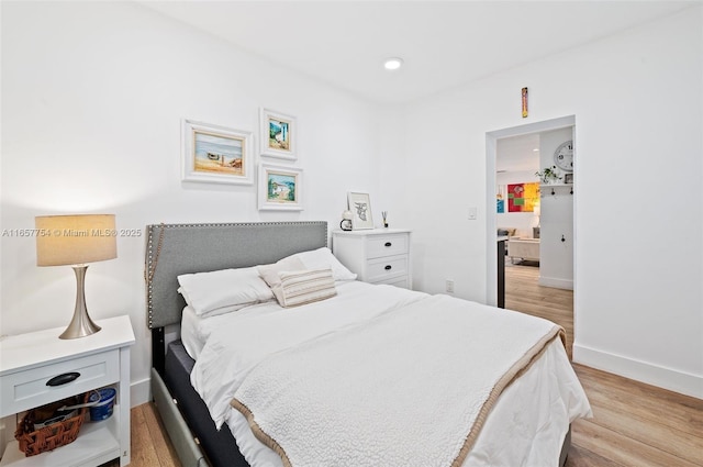 bedroom with recessed lighting, baseboards, and light wood-style flooring