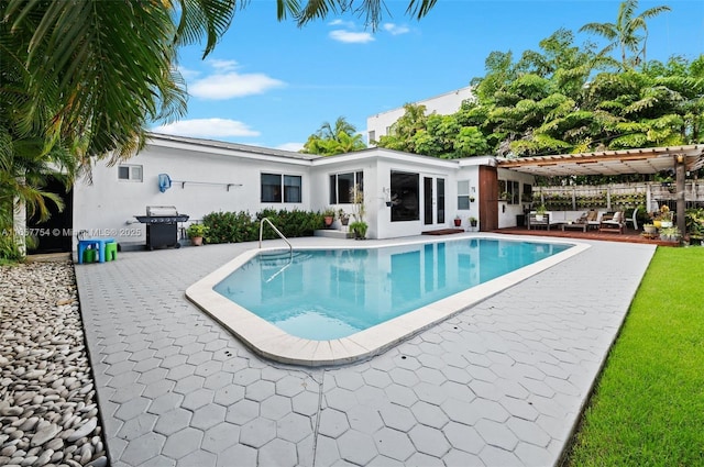 view of swimming pool featuring a fenced in pool, a patio area, a pergola, and grilling area