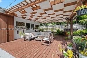 wooden deck featuring an outdoor living space and fence