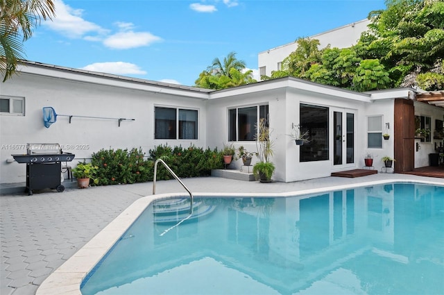 3551 E Glencoe St, Miami, FL 33133 - rear view of house featuring an outdoor pool, french doors, a patio area, and stucco siding