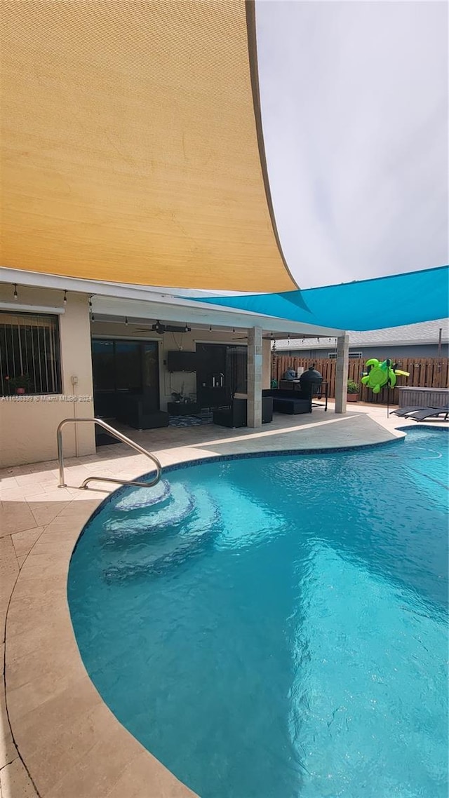 view of swimming pool featuring an outdoor living space and a patio area