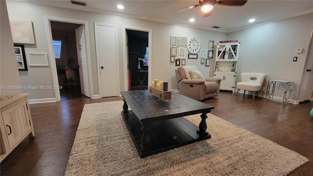 living room with ornamental molding, ceiling fan, and dark hardwood / wood-style floors