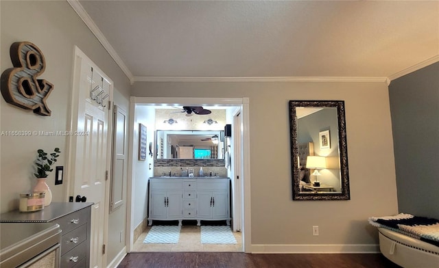 hall featuring crown molding, sink, and wood-type flooring