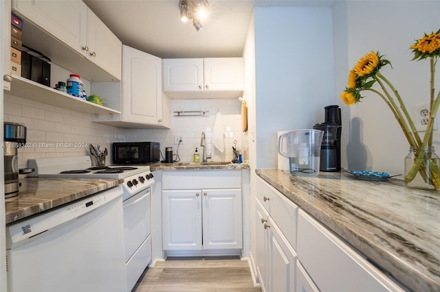 kitchen featuring white cabinets, sink, white appliances, light hardwood / wood-style flooring, and light stone countertops