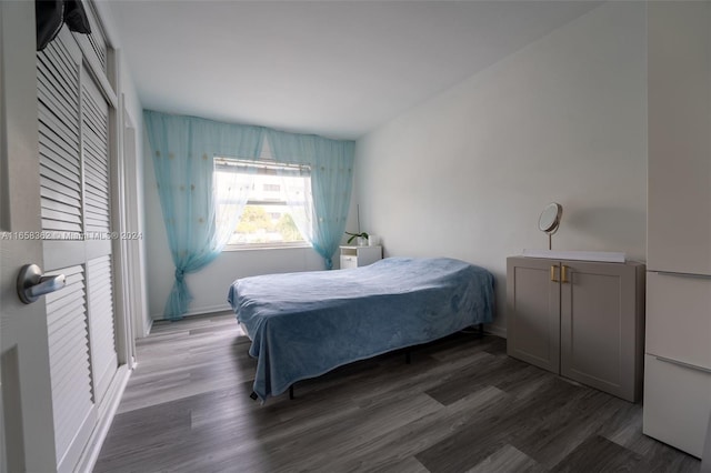 bedroom with dark hardwood / wood-style flooring