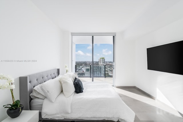 bedroom with a wall of windows and access to outside