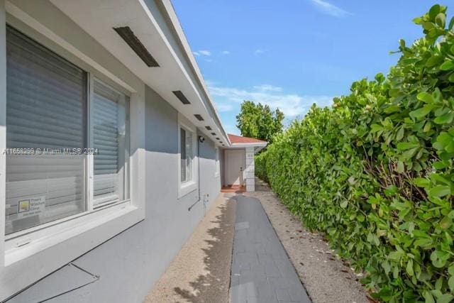 view of side of home with stucco siding