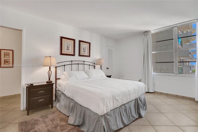 bedroom with light tile patterned floors