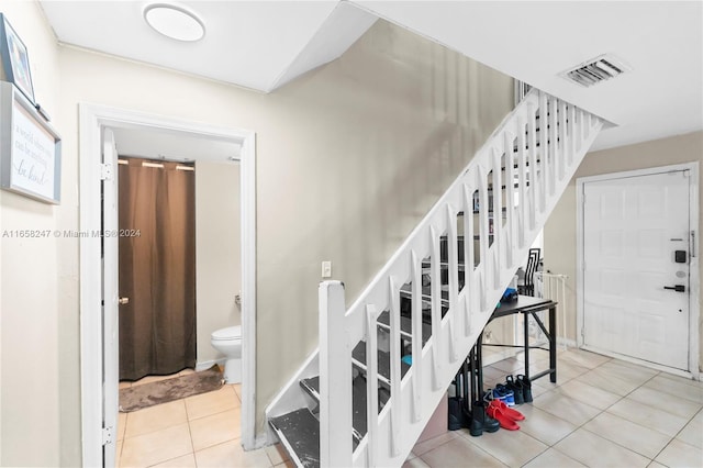 stairway with tile patterned floors