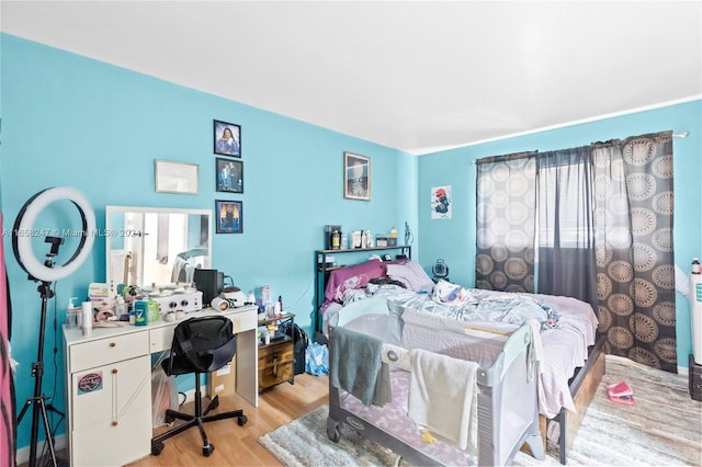 bedroom with light wood-type flooring and multiple windows