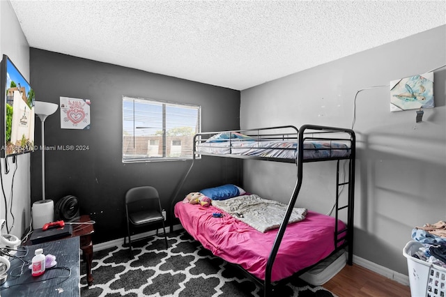 bedroom featuring a textured ceiling and hardwood / wood-style flooring