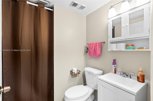 bathroom featuring vanity, toilet, and a shower with shower curtain