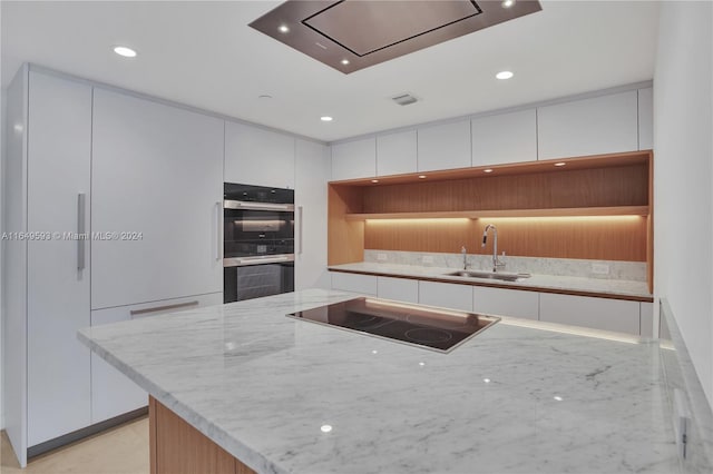 kitchen featuring black appliances, sink, and white cabinets