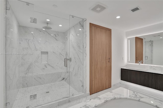 bathroom featuring vanity and a shower with shower door