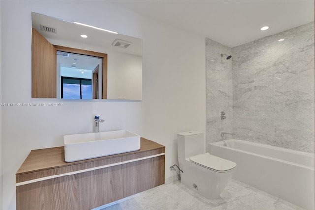 full bathroom featuring toilet, tiled shower / bath combo, and vanity