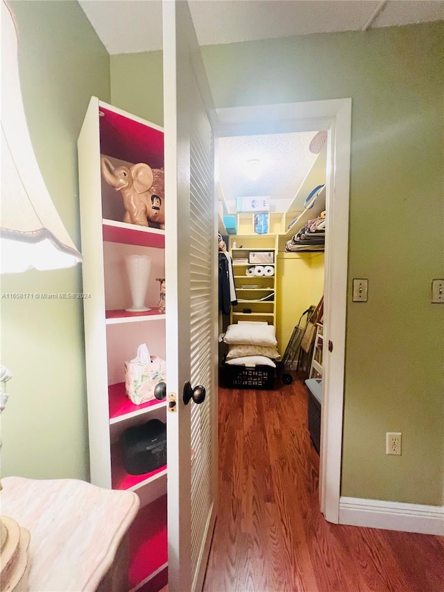 corridor featuring hardwood / wood-style floors