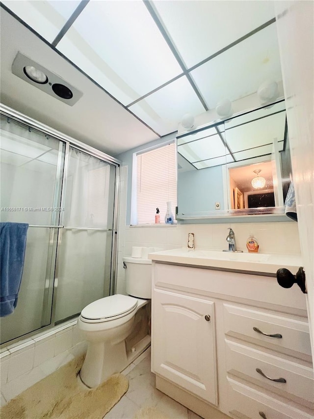 bathroom featuring walk in shower, vanity, and toilet