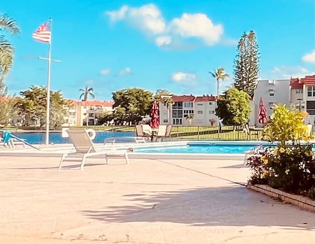 view of swimming pool featuring a patio area