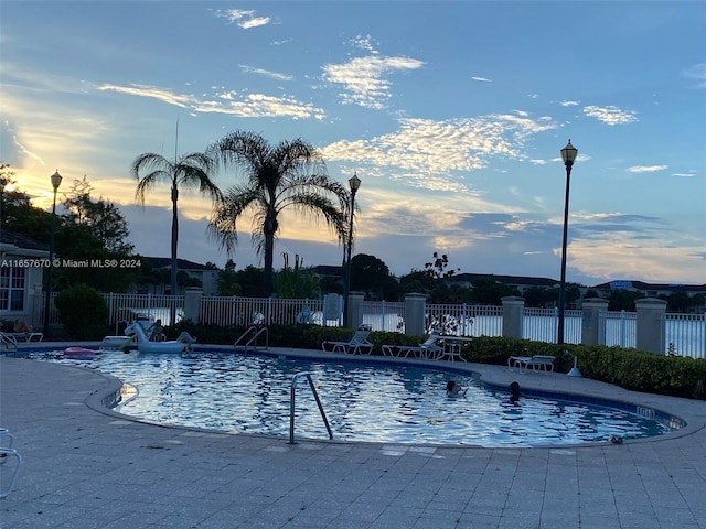 view of pool at dusk