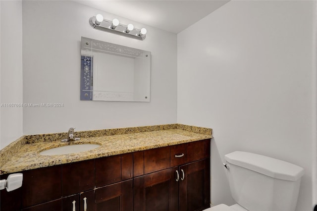 bathroom with toilet and vanity