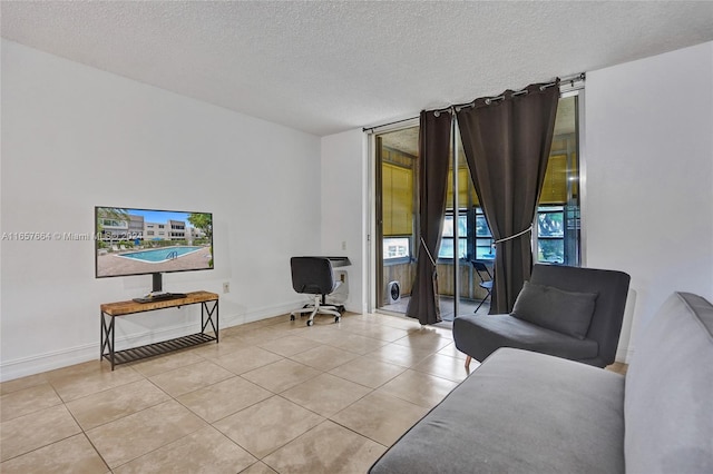 living room with a textured ceiling and light tile patterned flooring