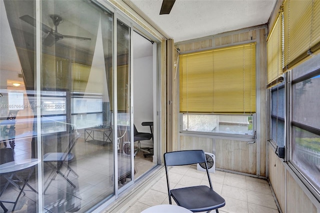 sunroom featuring ceiling fan