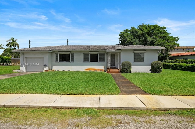 ranch-style home with a garage and a front yard