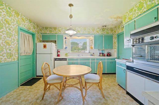 kitchen with decorative light fixtures, white appliances, and green cabinets