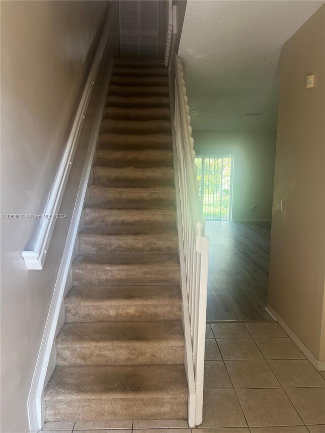 stairs featuring hardwood / wood-style flooring