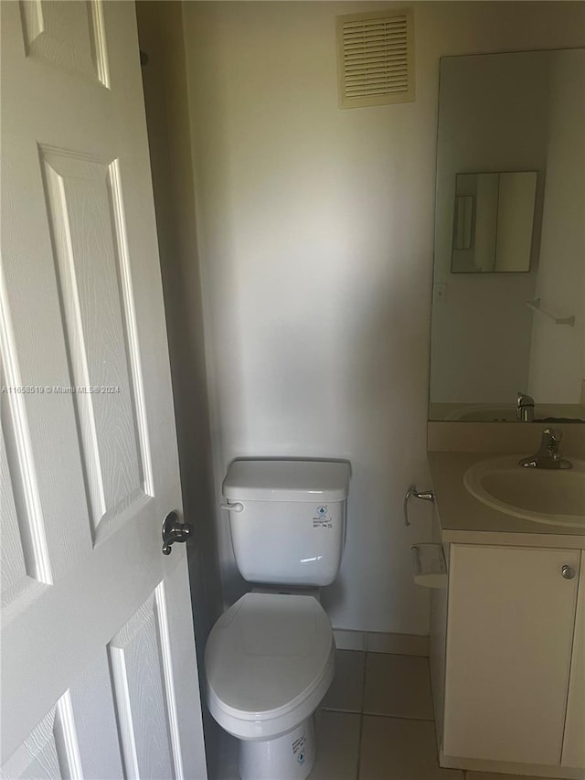 bathroom featuring vanity, toilet, and tile patterned floors