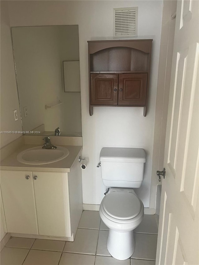 bathroom with vanity, toilet, and tile patterned floors