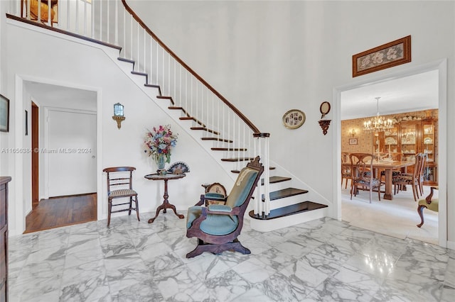 stairs with an inviting chandelier