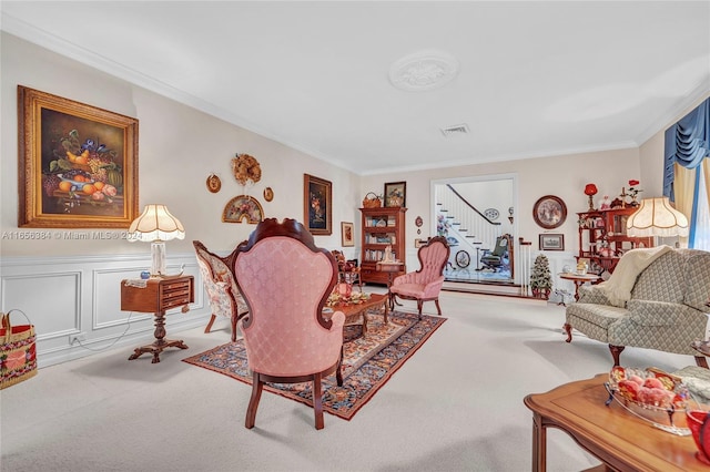 living room featuring crown molding and carpet flooring