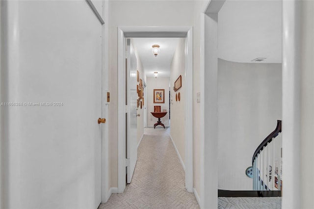 hallway featuring light carpet