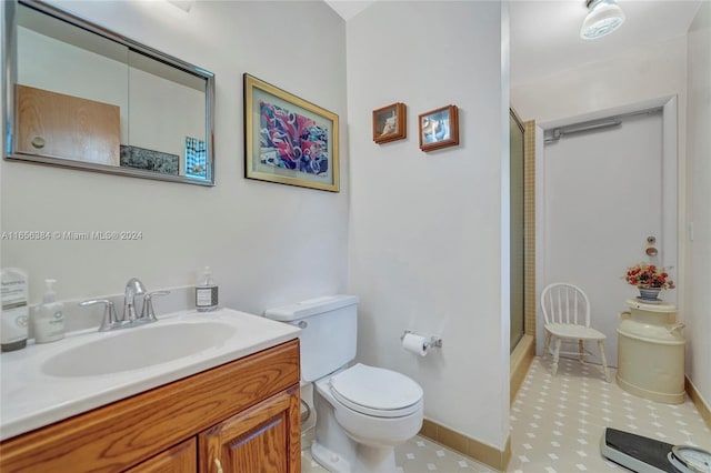 bathroom featuring vanity, toilet, an enclosed shower, and tile patterned floors