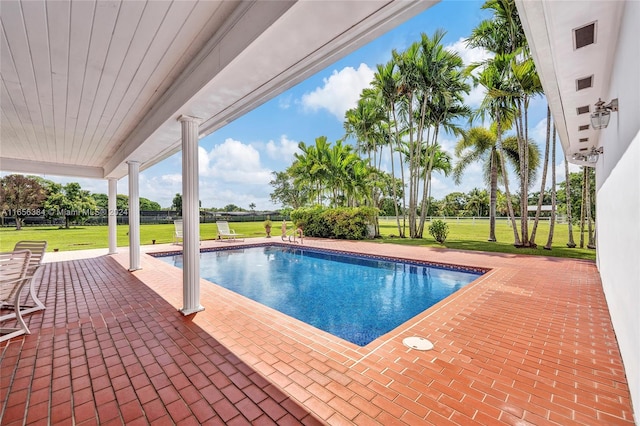 view of pool with a yard and a patio