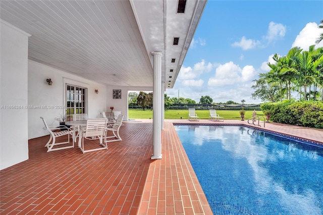 view of pool featuring french doors, a yard, and a patio