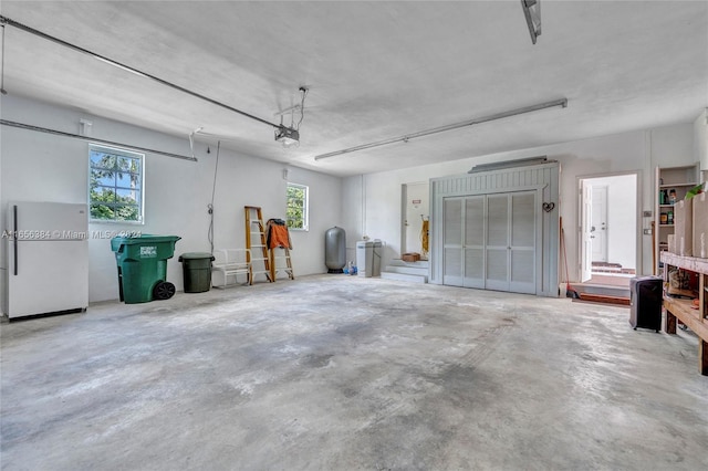 garage with white refrigerator and a garage door opener