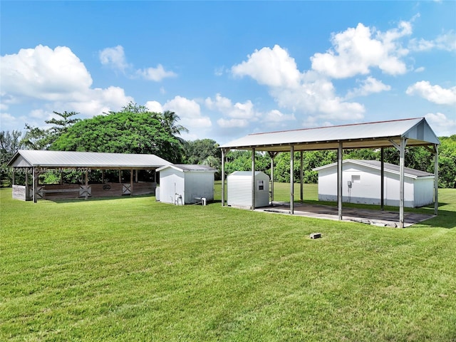 view of yard with a carport and a shed