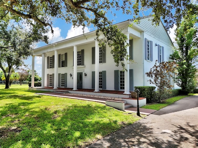 view of front of property with a front yard and a porch