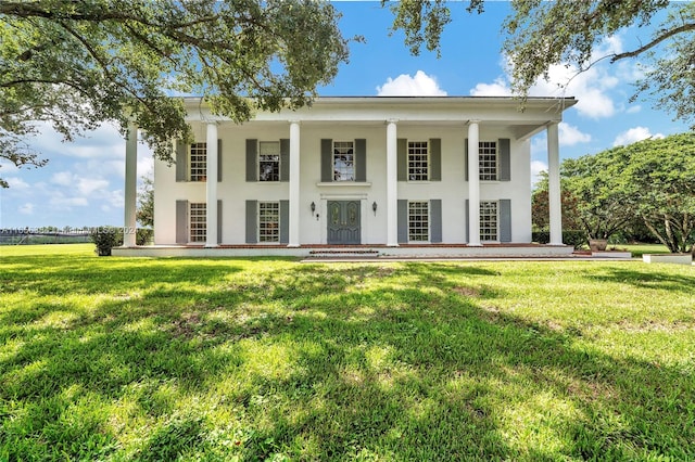 rear view of property with a lawn