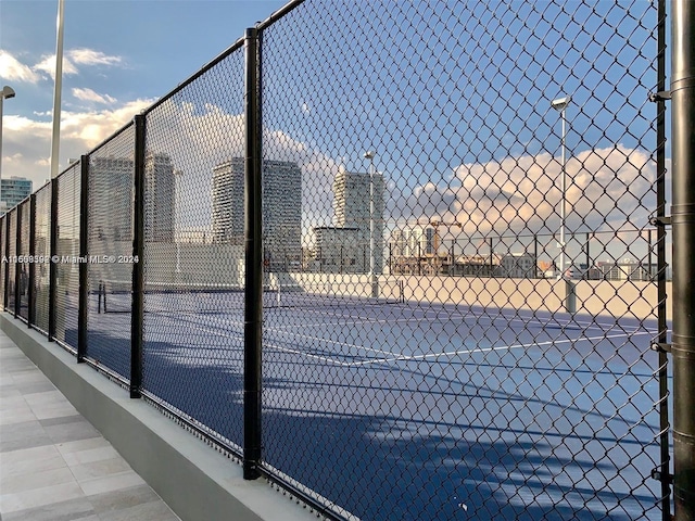 view of sport court featuring fence