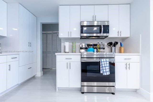 kitchen featuring white cabinets and appliances with stainless steel finishes