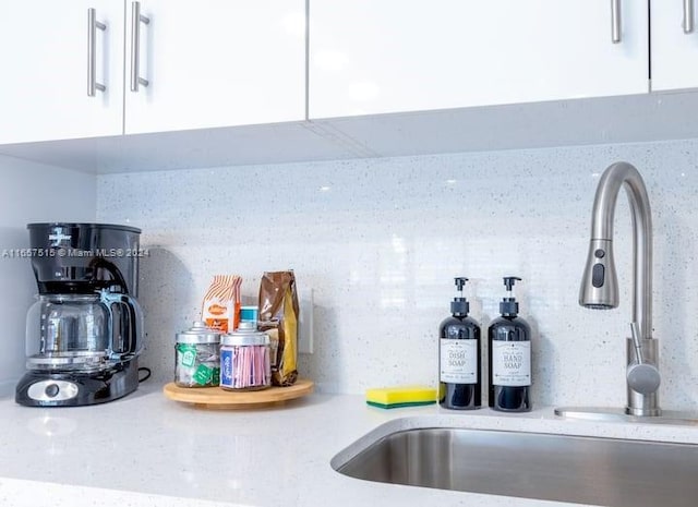 room details featuring white cabinetry and sink